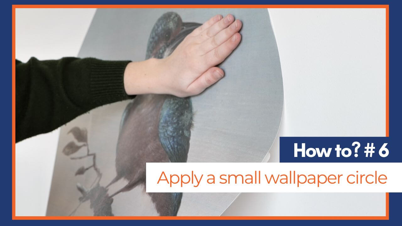 woman applying a wallpaper circle